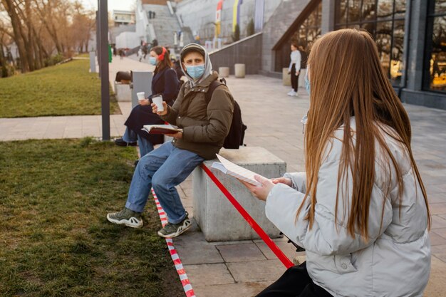 Photo people with mask at distance from each other