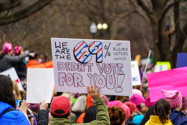 people with text on placard in city during protest
