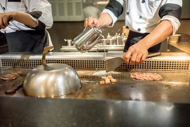 People working on barbecue grill