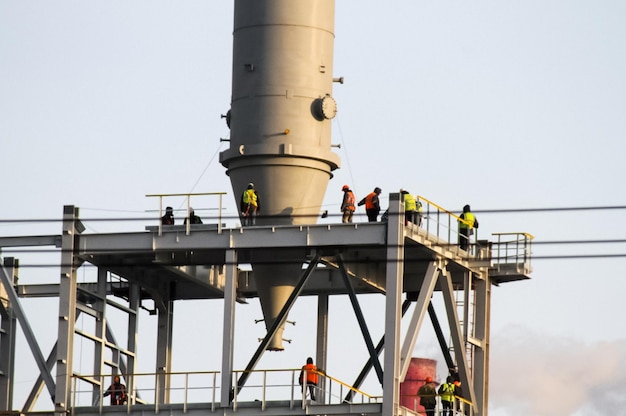 People working at construction site against clear sky