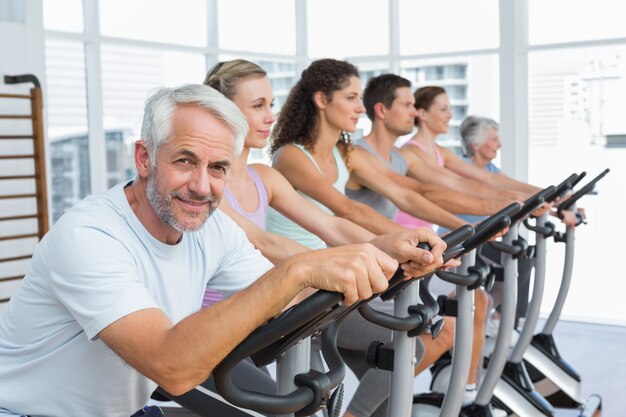 People working out at spinning class in gym