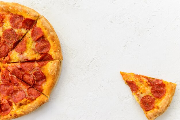 Peperoni pizza on a light table.