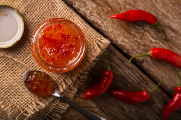 Photo pepper jam in glass jar on the table