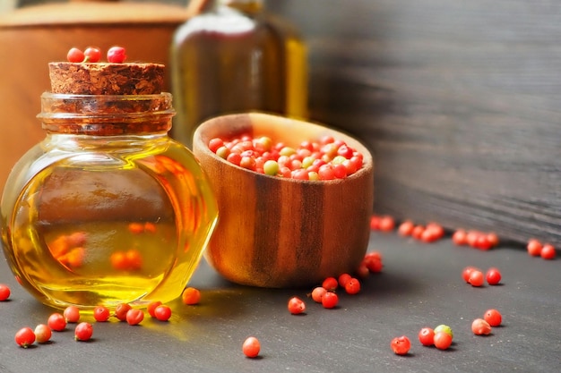 Pepper oil pink Brazilian pepper olive oil wooden salt shaker Spicy food preparation concept
