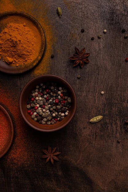 Photo pepper and other spices on a brown background