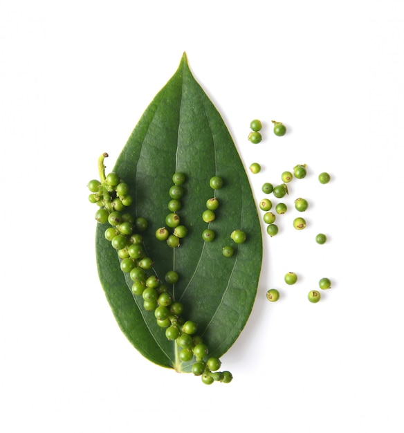 Peppercorns with leaf isolated on a white surface. top view