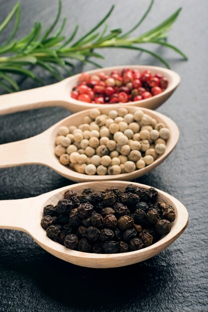 Peppercorns in wooden spoons