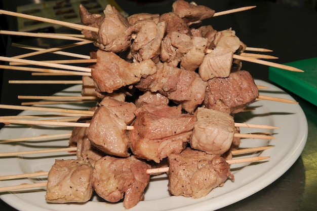 Peppered loin skewers served on a white plate