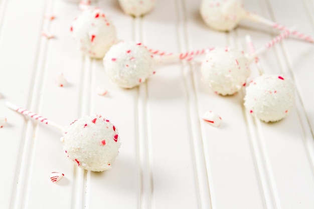 Peppermint chocolate cake pops dipped in white chocolate and candy cane bits.