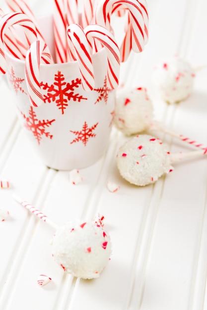 Peppermint chocolate cake pops dipped in white chocolate and candy cane bits.