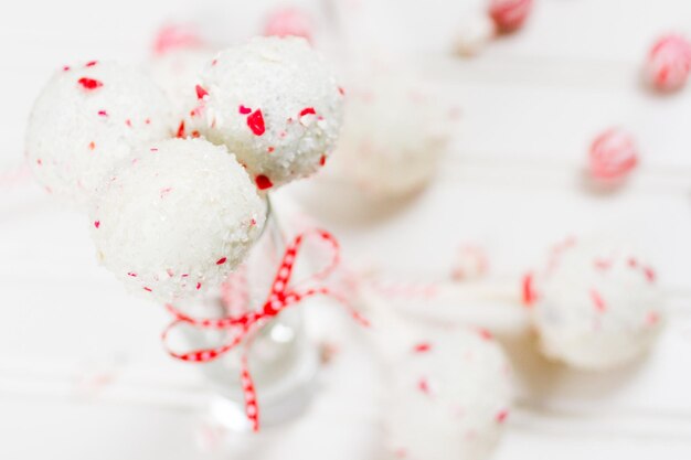 Peppermint chocolate cake pops dipped in white chocolate and candy cane bits.