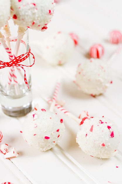 Peppermint chocolate cake pops dipped in white chocolate and candy cane bits.