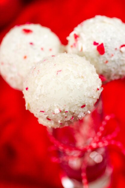 Peppermint chocolate cake pops dipped in white chocolate and candy cane bits.