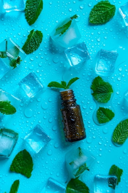 Peppermint essential oil with ice cubes Selective focus