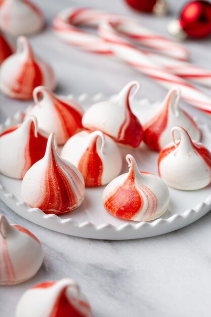 Peppermint meringues on a marble table christmas treat