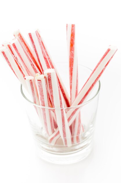 Peppermint stirrers in glass cup.