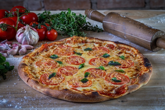 Pepperoni and cheese pizza on the table