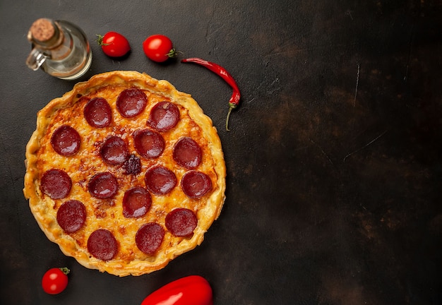 Pepperoni homemade pizza on stone background with copy space for your text.