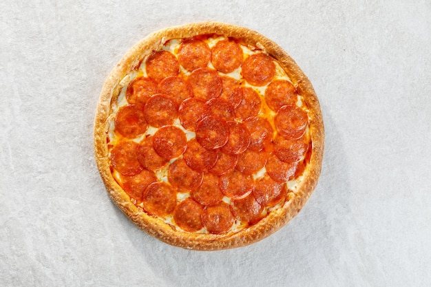 Pepperoni pizza over grey background