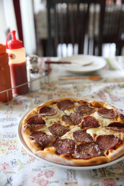 Pepperoni pizza, pizza met pepperoni mozzarella kaas en tomaten met saus achtergrond Italiaans eten