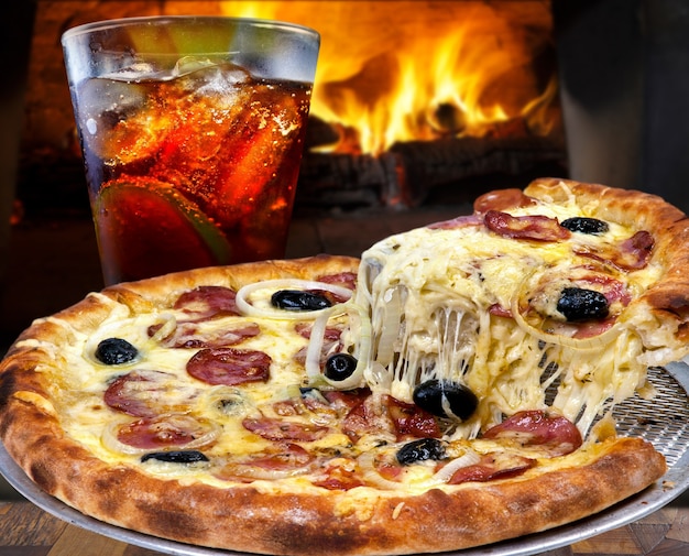 Pepperoni pizza with mozzarella, black olives, onion and cola soda