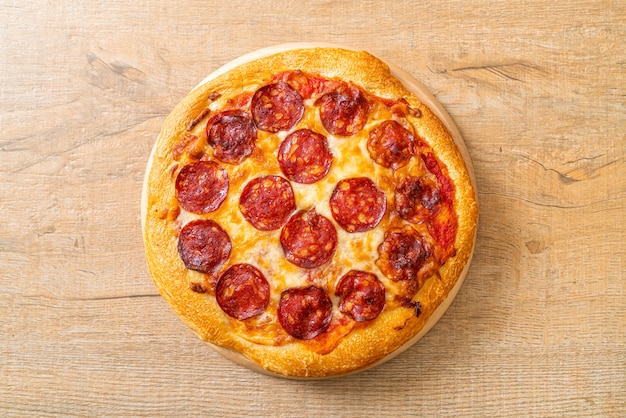 pepperoni pizza on wood tray. Italian food style