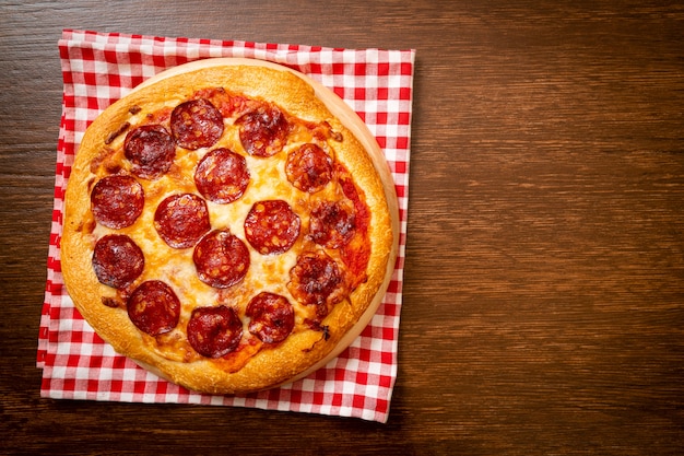 Pepperoni pizza on wood tray