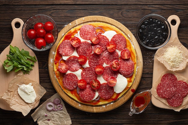  Pepperoni pizza on wooden board top view