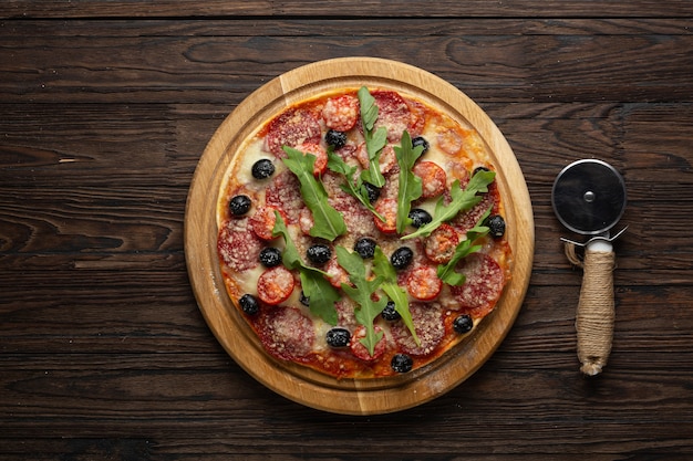  Pepperoni pizza on wooden board top view