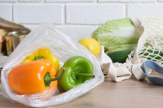 Peppers in a plastic bag on a wooden kitchen table