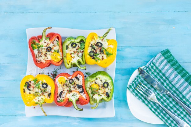 Peppers stuffed with rice and cheese vegetarian food wooden background top view