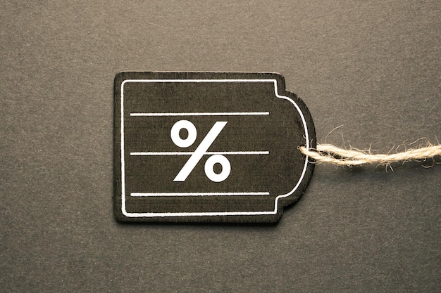 percent sign on the black price tag, black mockup background