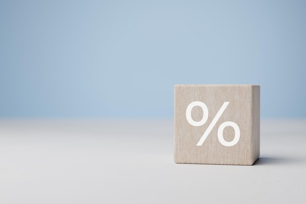 Percent sign wood cube block with percentage symbol icon Concept of interest rate and financial rates percentage symbol copy space blue background