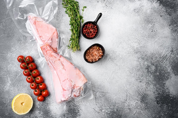 Perch frozen fish meat pack  set, with herbs, on gray stone table background, top view flat lay, with copy space for text