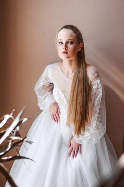 Perfect bride portrait of a girl in a long white dress Beautiful hair and clean delicate skin