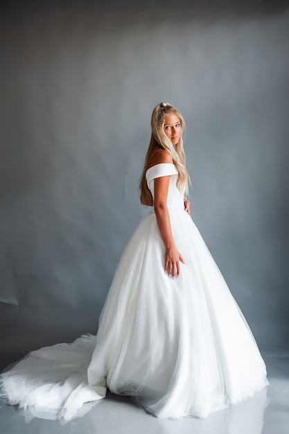 Perfect bride portrait of a girl in a long white dress