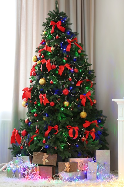 Perfect Christmas tree with gifts underneath in living room