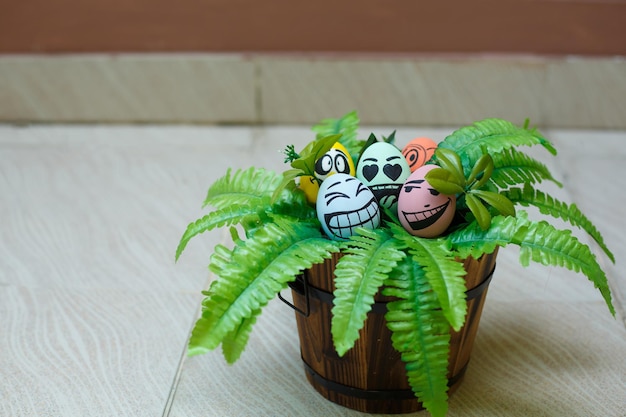 Perfect colorful handmade easter eggs with green plant isolated on a brown background Easter day concepts Funny decoration Happy Easter