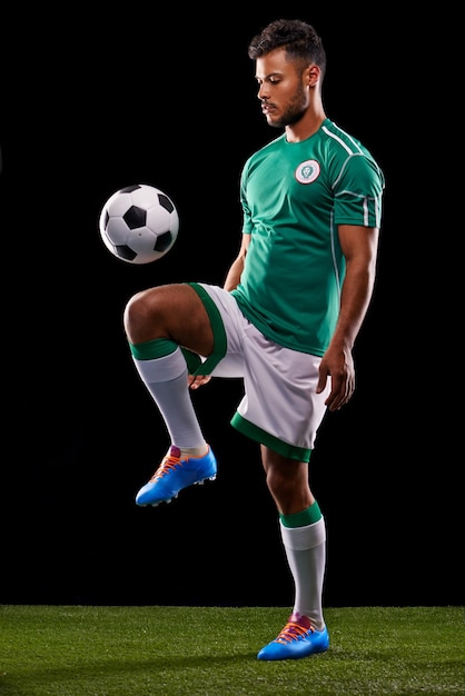 Perfect control Full length studio shot of a handsome young soccer player isolated on black