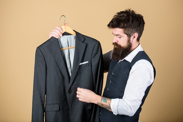 Perfect fit. Custom made to measure. Tailored suit concept. Fashion for business people. Custom made suit. Man bearded fashion couturier tailor. Elegant custom suit. Tailoring and clothes design.