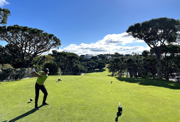 Perfect golf day male golfer on the golf course with golf club and getting ready to hit