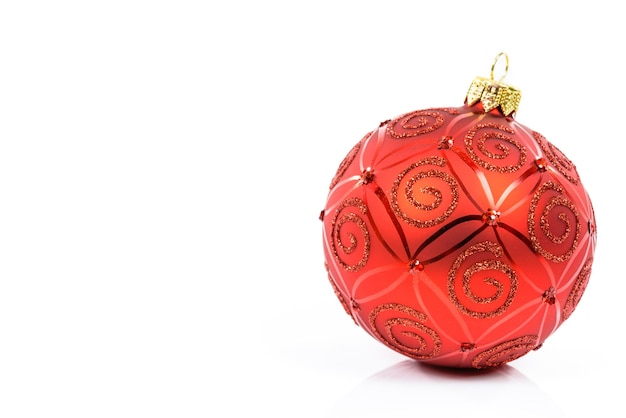 Perfect and ideal red glass Christmas ball on a white background in closeup with copy place