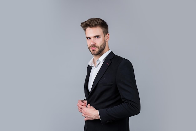 Perfect male confident businessman portrait Portrait of a handsome CEO Businessman in suit Young handsome man Young manager in his office portrait of a businessman on grey background