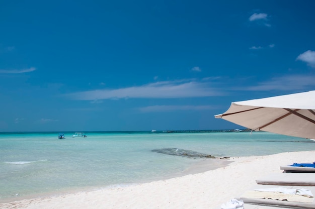 Photo a perfect morning on the beautiful white sand beach with a chaise lounge and umbrella