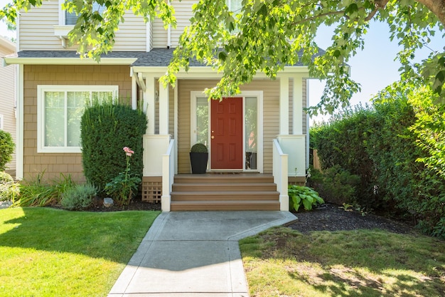 Photo perfect neighbourhood door steps and concrete pathway leading to residential house main entrance with flower pot under the porch