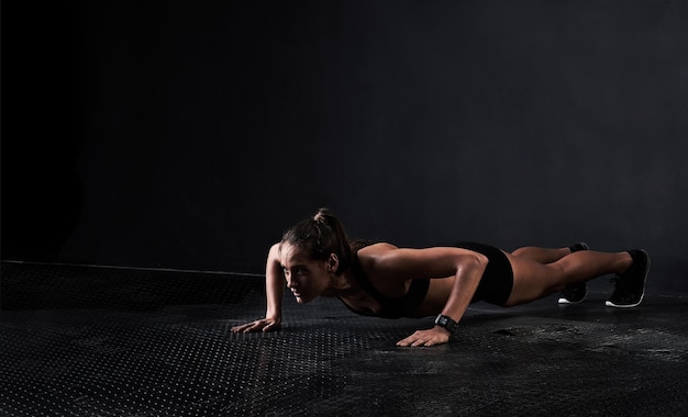 The perfect pushup Studio shot of a woman working out against a dark background