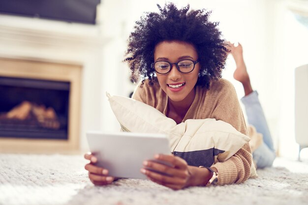 The perfect weekend is just an ebook away Shot of a young woman using a digital tablet at home