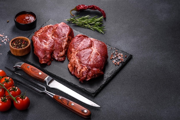 Perfecte rauwe rib eye biefstuk op zwarte houten ondergrond, close-up