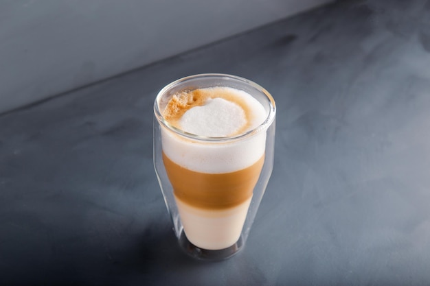 Perfectly gradient latte macchiato view over grey backdrop with copy space