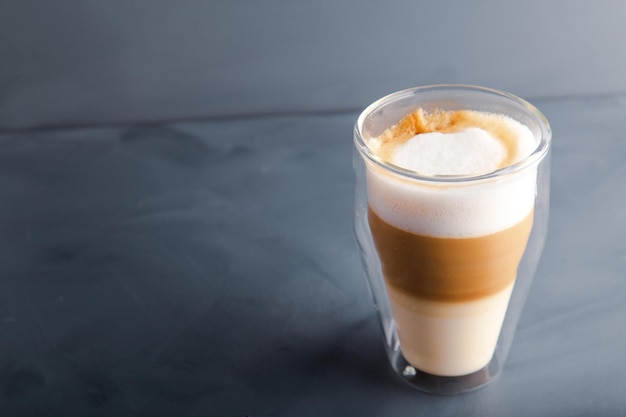Perfectly gradient latte macchiato view over grey backdrop with copy space